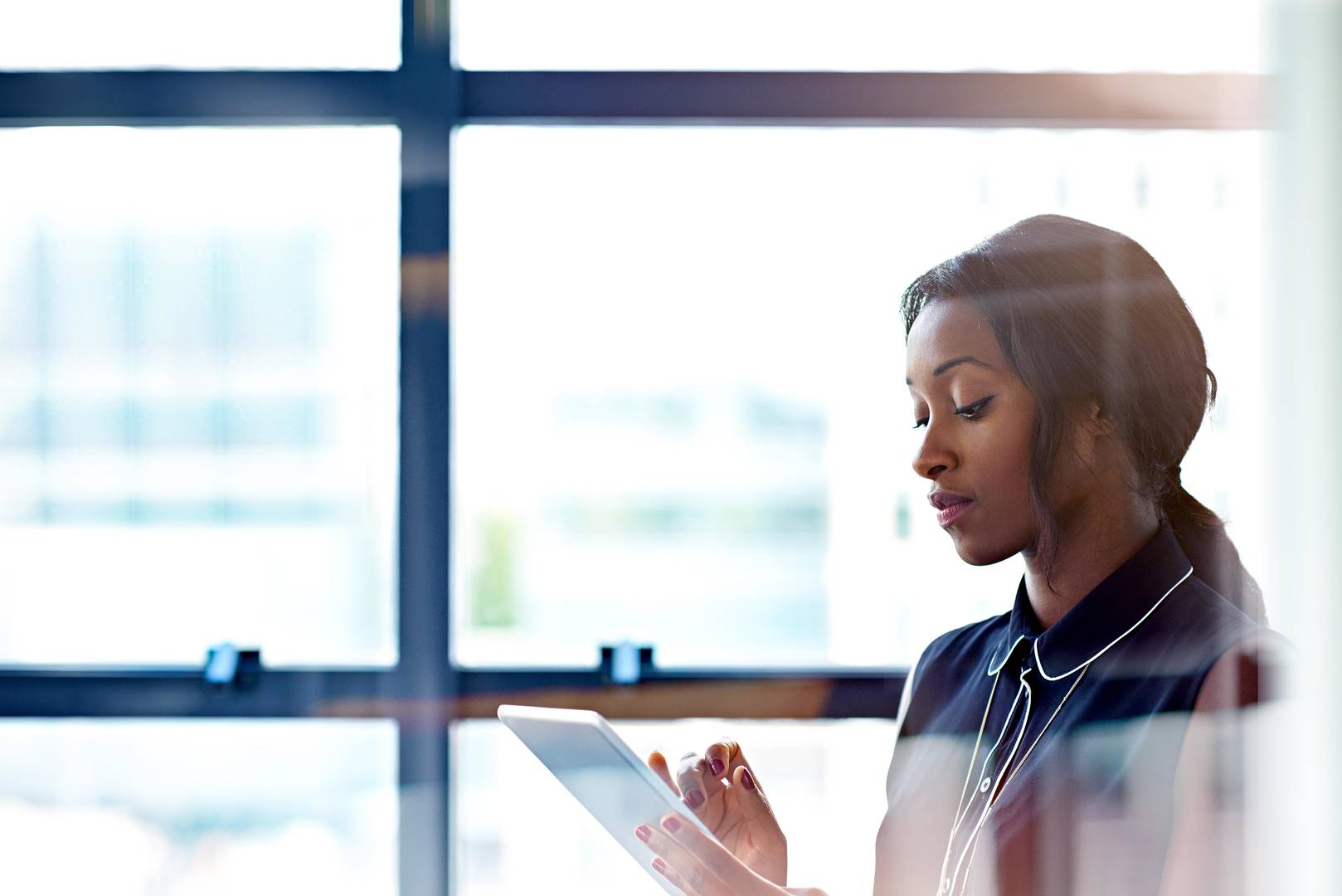Woman using digital tablet in office setting